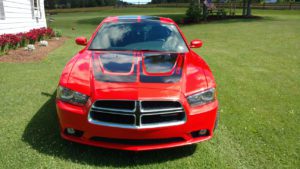 Front hood of Red Dodge Charger with hood and roof decals