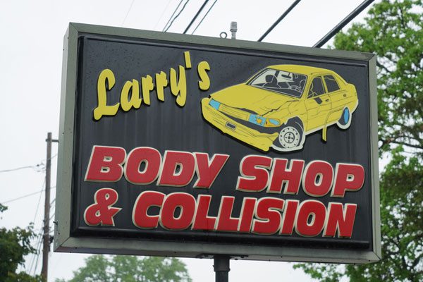 Exterior signage for Larry's Body Shop in Watsontown, PA